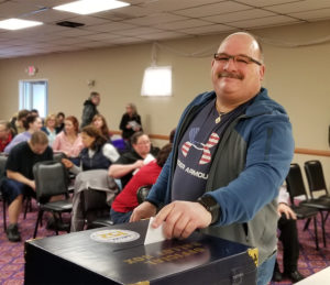 An Acme Markets member voting on the proposed contract.