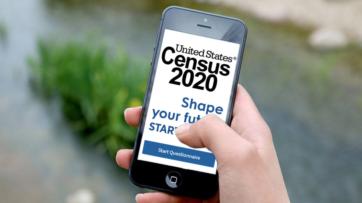 A person holding an iphone, getting ready to take the U.S. Census in 2020.