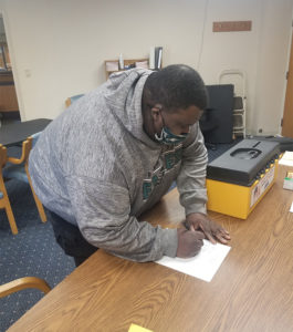 A member from Southgate Health Care Center voting at the ratification on 3/4/2021.