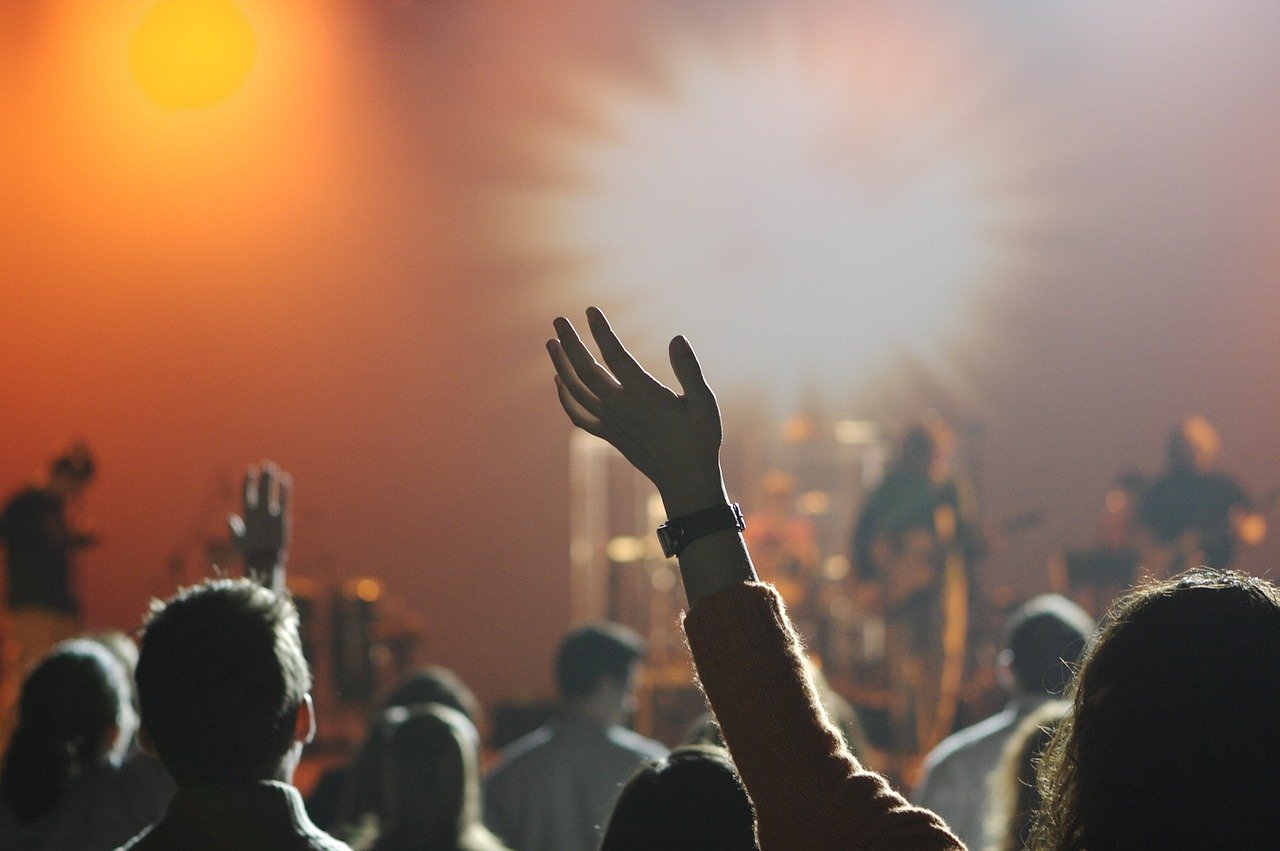 People at a concert venue People at a concert venue