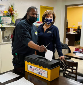 Assistant Director of Collective Bargaining Lisa Sanders with Local 152 member English as he casts his vote on 2/2/2022.