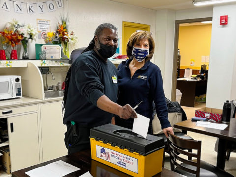 Assistant Director of Collective Bargaining Lisa Sanders with Local 152 member English as he casts his vote on 2/2/2022.