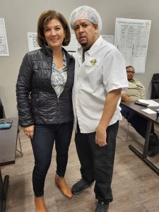 A member with Assistant Director of Collective Bargaining Lisa Sanders at the Top Quality Baking ratification in 2022.