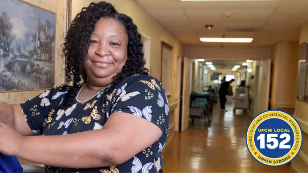 A healthcare worker posing in a hallway.